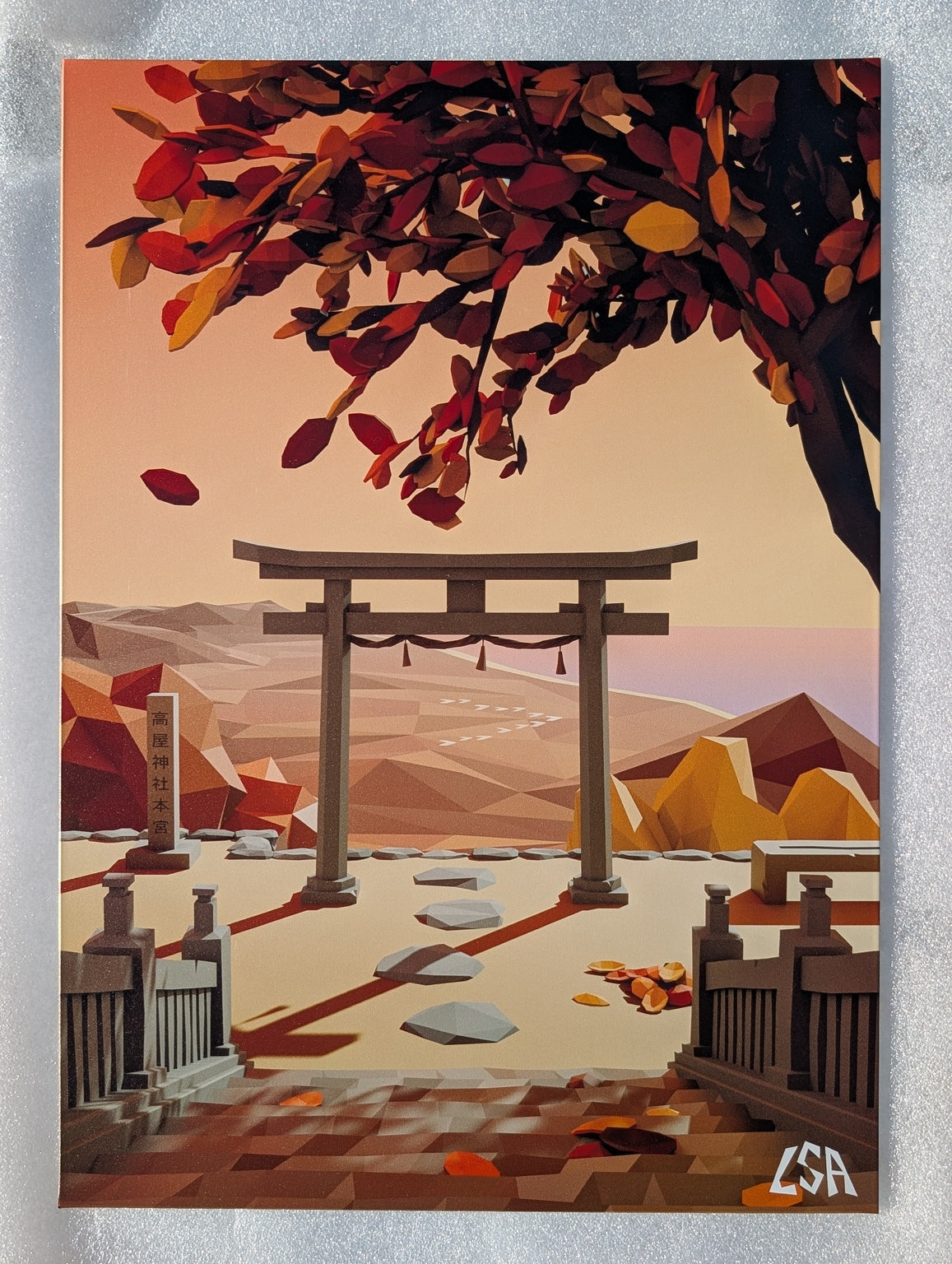 A low-poly stylized aluminium print depicting an autumn sunset in japan with a torii gate, mountains, and a tree of red and yellow leaves.
