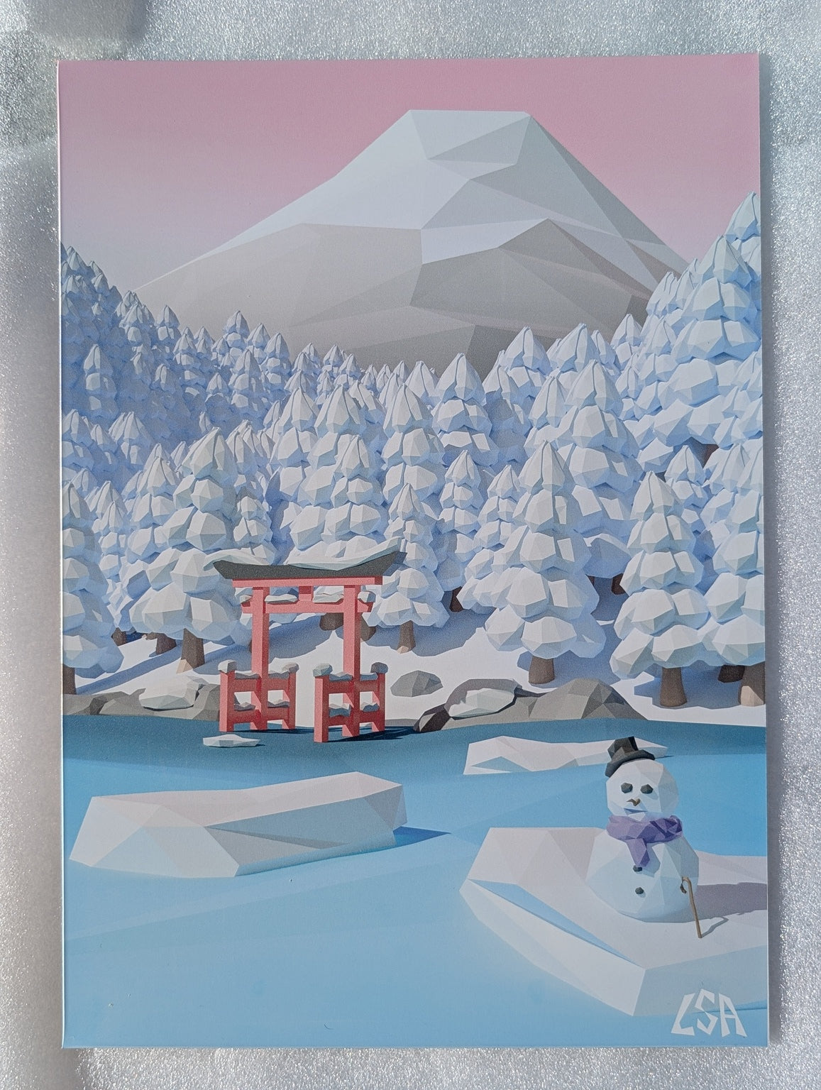 Aluminium print featuring a stylized low-poly winter scene with snow-covered trees, a red torii gate, a small snowman, and mount fuji with blue, white, and pink tones.
