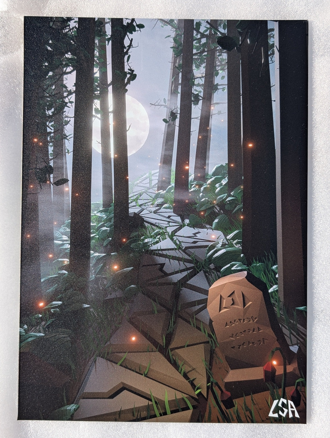 Aluminium print showing a paved trail in a mystic forest with fireflies a gravestone a full moon and trees during night time, in low-poly style.