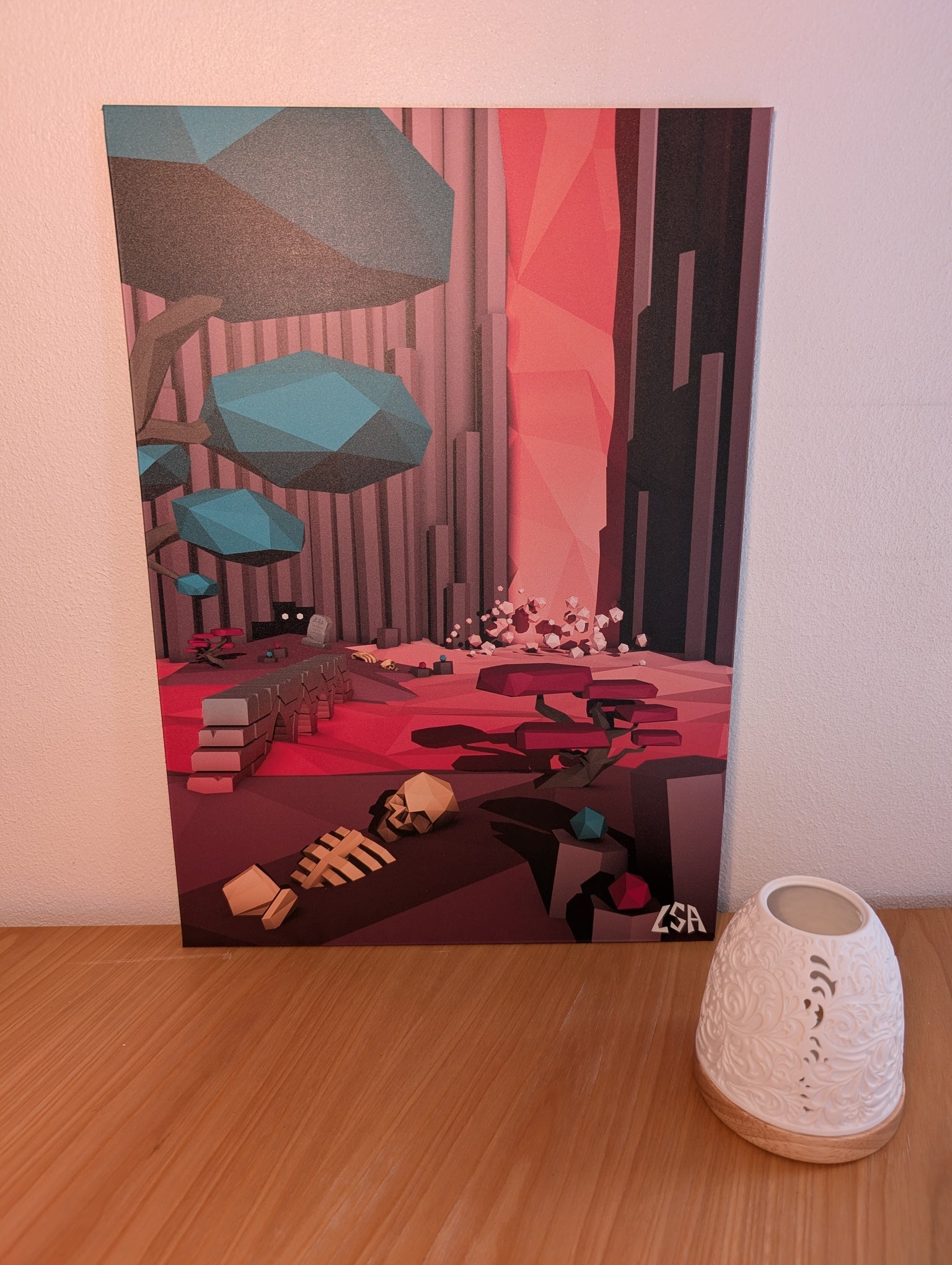 A stylized low-poly aluminium print depicting a futuristic canyon landscape with a waterfall, geometric trees, a glowing pink-red canyon wall, and a skeleton on the ground, shown against a light gray background.
