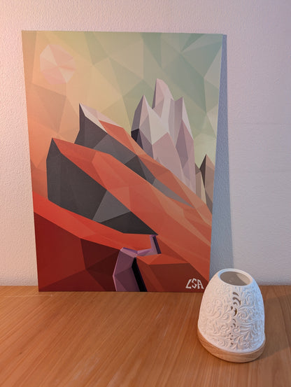 A low-poly geometric aluminium print featuring abstract mountains in orange, red, gray